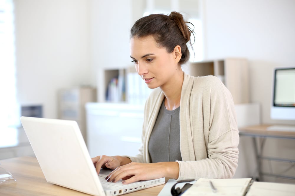 Woman working in office on laptop