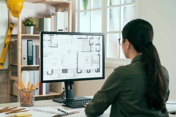 Stock_Woman facing Computer with Plan_600x400